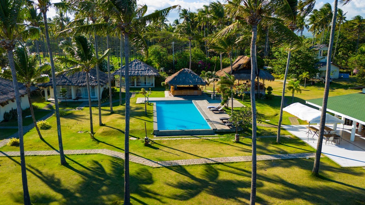 Stunning aerial view of a tropical resort with a pool and lush greenery in Bacong, Central Visayas.